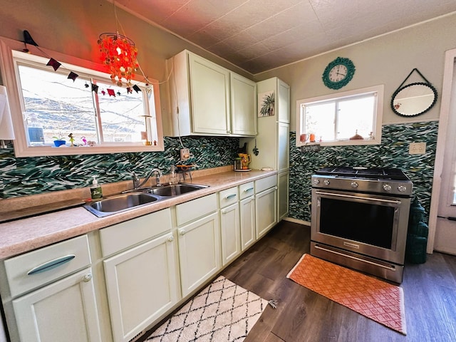 kitchen featuring hanging light fixtures, dark hardwood / wood-style floors, sink, and high end stainless steel range oven