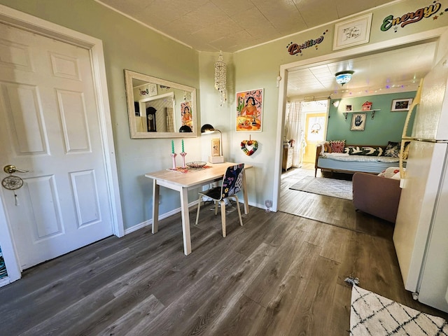 bedroom with dark wood-type flooring and white refrigerator