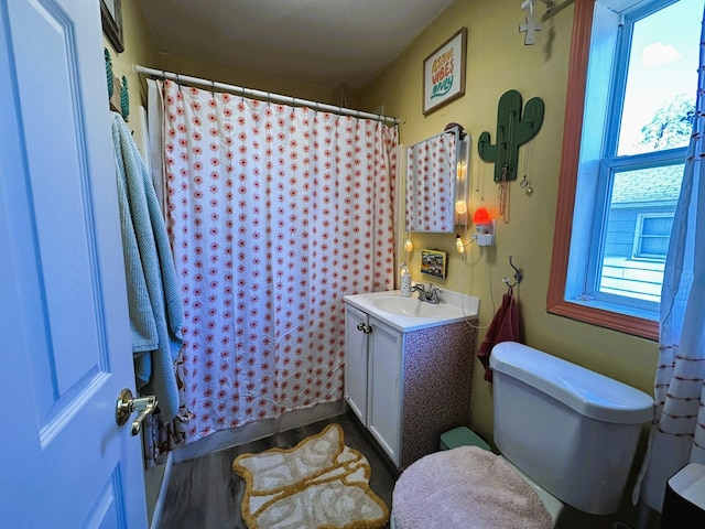 bathroom with vanity, a shower with shower curtain, plenty of natural light, and toilet