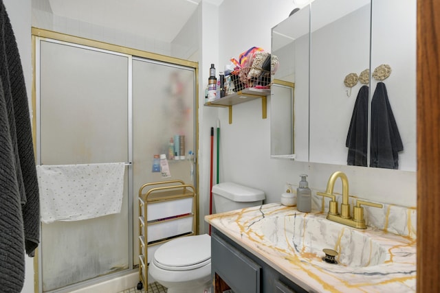 bathroom with vanity, toilet, and an enclosed shower