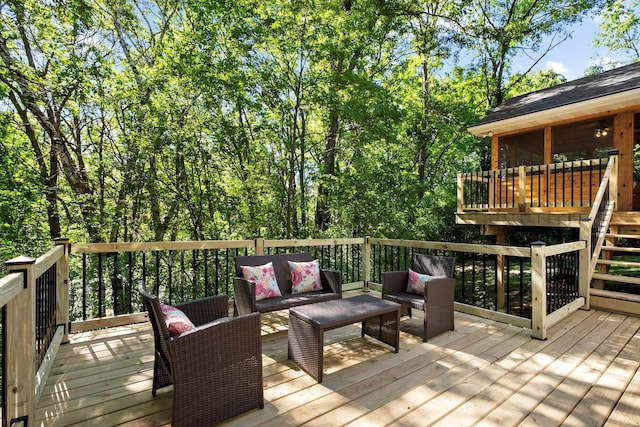 wooden deck with an outdoor living space and a sunroom