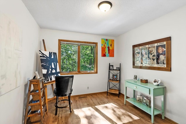 office featuring hardwood / wood-style floors and a textured ceiling