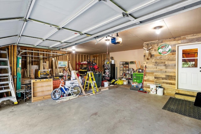 garage featuring wood walls and a garage door opener