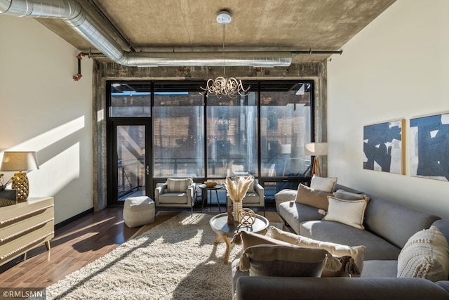 living room featuring a notable chandelier and hardwood / wood-style flooring