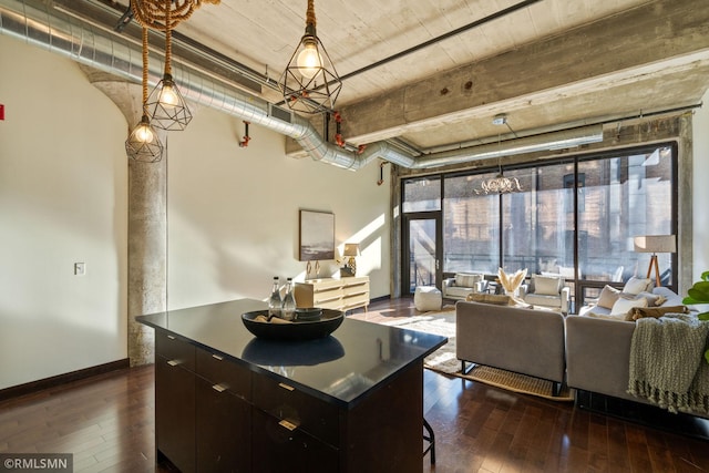 kitchen featuring dark hardwood / wood-style flooring, hanging light fixtures, and a kitchen island