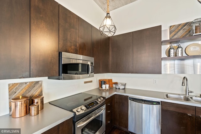 kitchen with sink, dark brown cabinets, hanging light fixtures, and appliances with stainless steel finishes