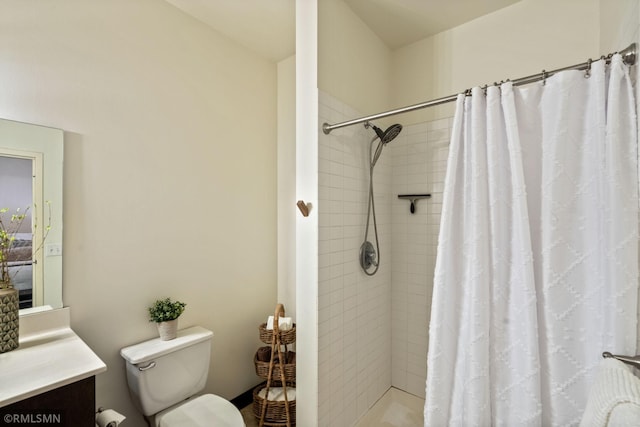 bathroom featuring vanity, toilet, and a shower with shower curtain