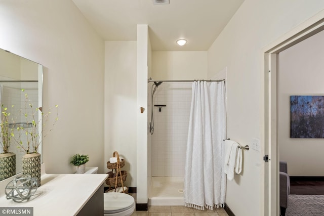 bathroom featuring vanity, toilet, curtained shower, and tile patterned flooring