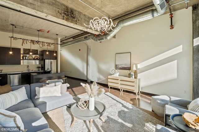 living room featuring sink and hardwood / wood-style flooring