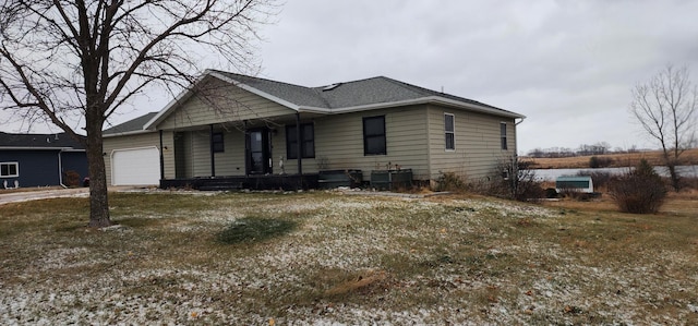 view of front of house with a front yard and a garage