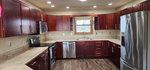 kitchen with dark hardwood / wood-style flooring, sink, and appliances with stainless steel finishes