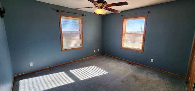 carpeted spare room with ceiling fan