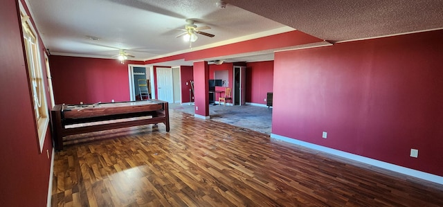 unfurnished bedroom featuring a textured ceiling, dark hardwood / wood-style flooring, and billiards