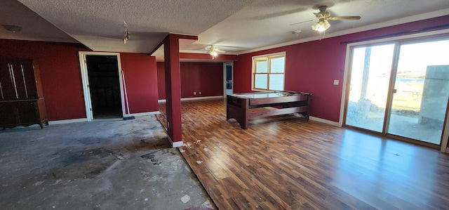 interior space featuring ceiling fan, dark hardwood / wood-style flooring, a textured ceiling, and pool table