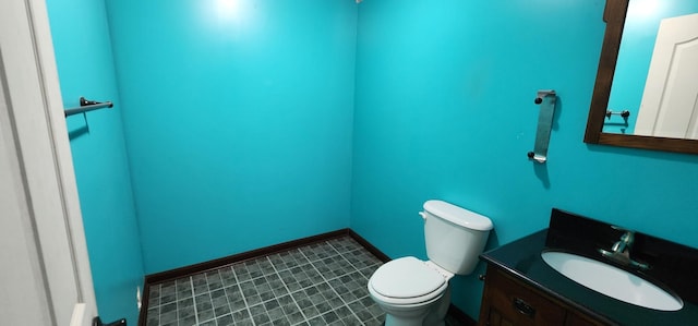 bathroom featuring tile patterned flooring, vanity, and toilet