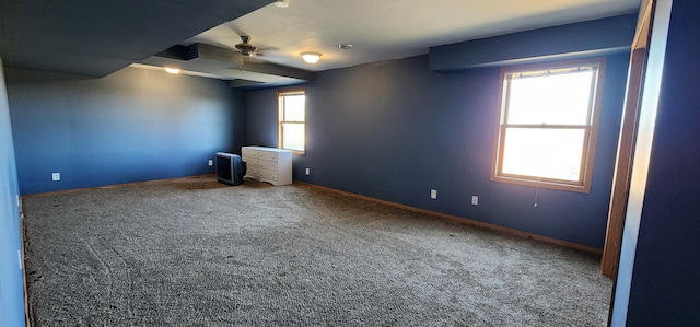 unfurnished room with ceiling fan and carpet