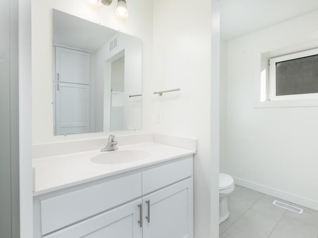 bathroom with tile patterned floors, vanity, and toilet