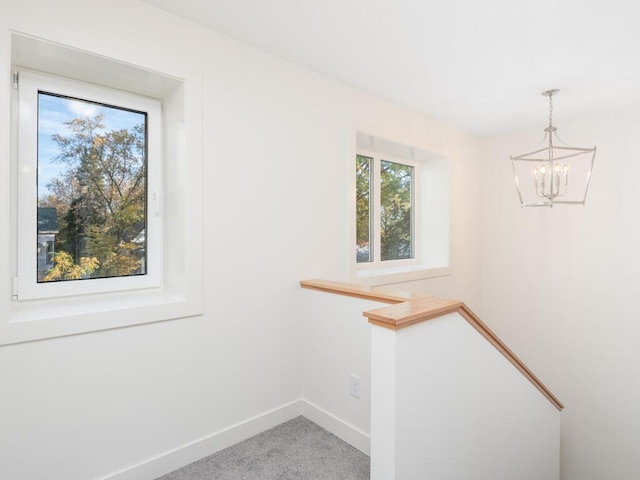 interior space featuring a chandelier and carpet