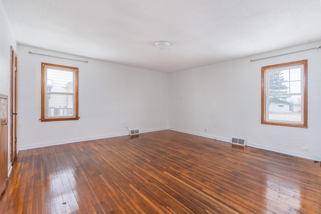 unfurnished room with dark hardwood / wood-style floors