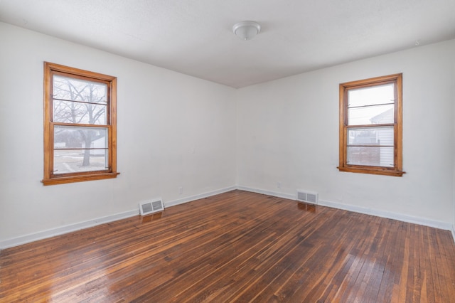 empty room with dark hardwood / wood-style floors