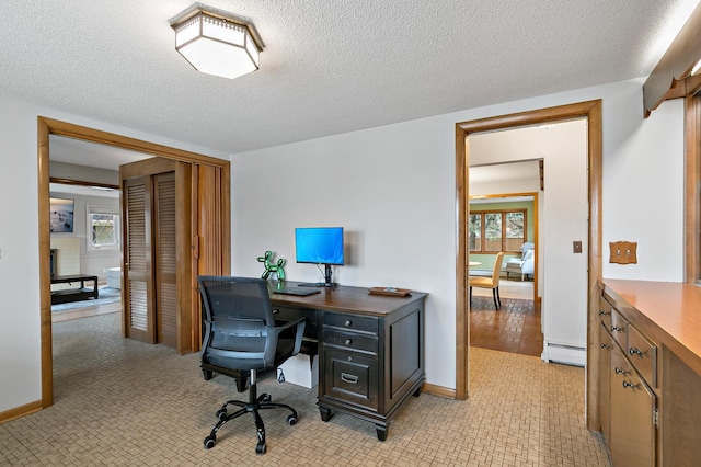 office featuring baseboard heating and a textured ceiling