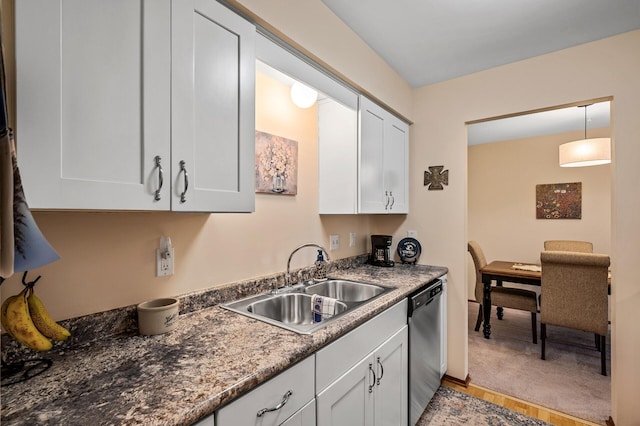 kitchen with white cabinetry, sink, dark stone counters, decorative light fixtures, and dishwasher