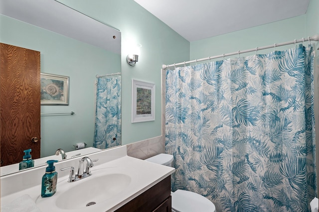 bathroom featuring toilet and vanity