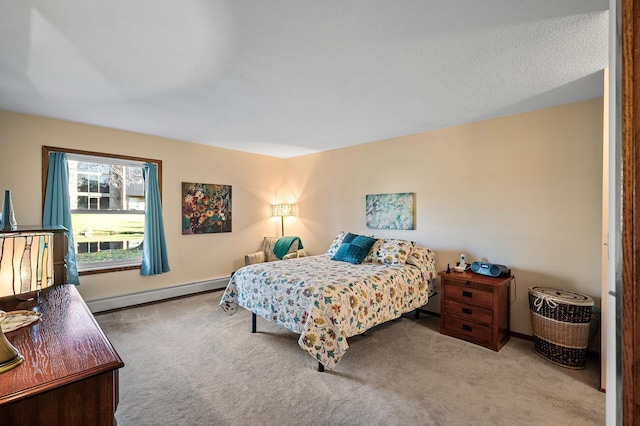 carpeted bedroom featuring a baseboard heating unit