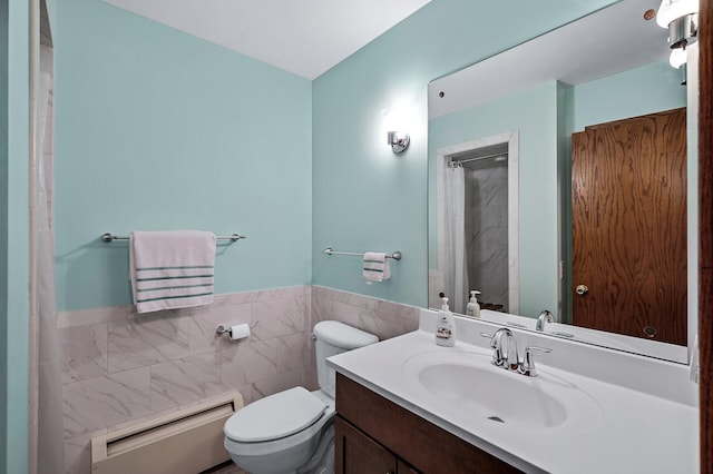 bathroom with vanity, a baseboard radiator, toilet, and tile walls