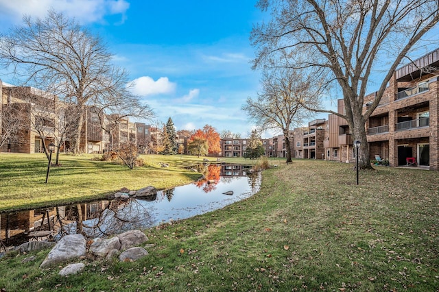 view of property's community featuring a water view and a lawn