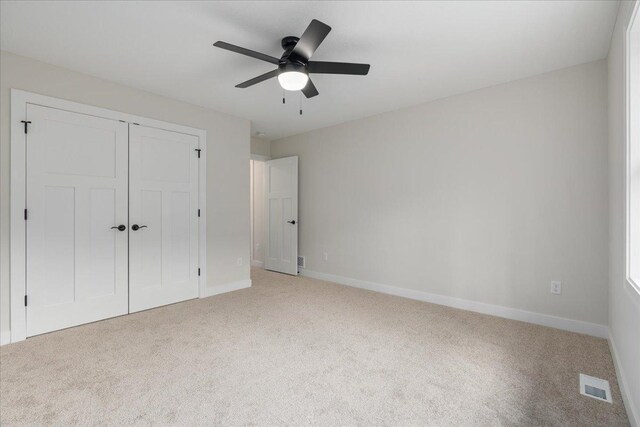 S1546 Shawnee Dr Unit A, Alma, WI 54610 - unfurnished bedroom featuring carpet flooring, a closet, baseboards, and a ceiling fan