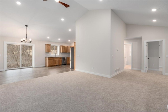 S1546 Shawnee Dr Unit A, Alma, WI 54610 - unfurnished living room featuring light colored carpet, a chandelier, a ceiling fan, recessed lighting, and baseboards