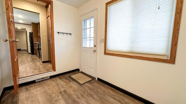 doorway with hardwood / wood-style floors