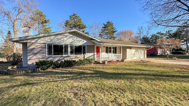 single story home with a porch, a garage, and a front lawn