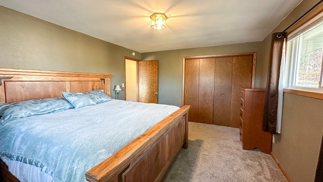 bedroom featuring light carpet and a closet