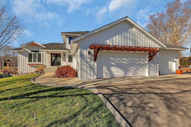 view of front of house with a garage and a front lawn