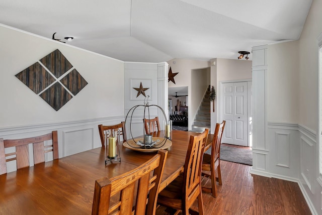 dining space with vaulted ceiling and hardwood / wood-style flooring