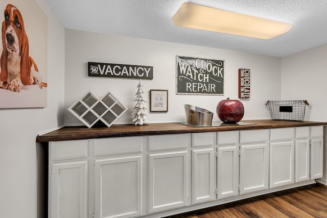 room details featuring hardwood / wood-style floors and a textured ceiling