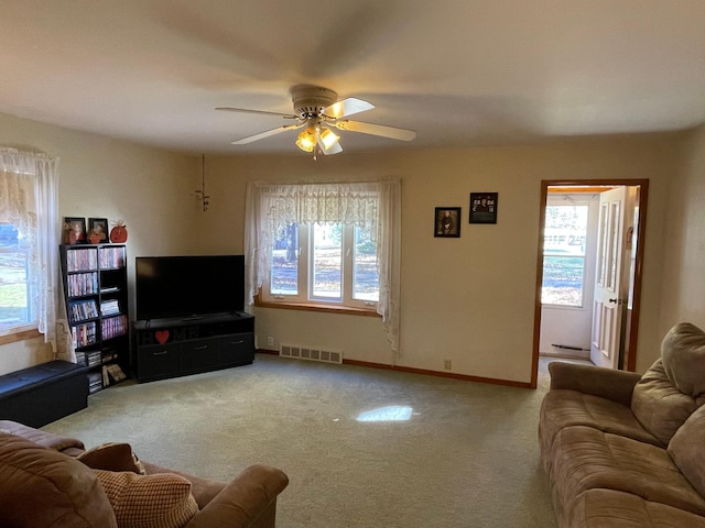 carpeted living room featuring ceiling fan