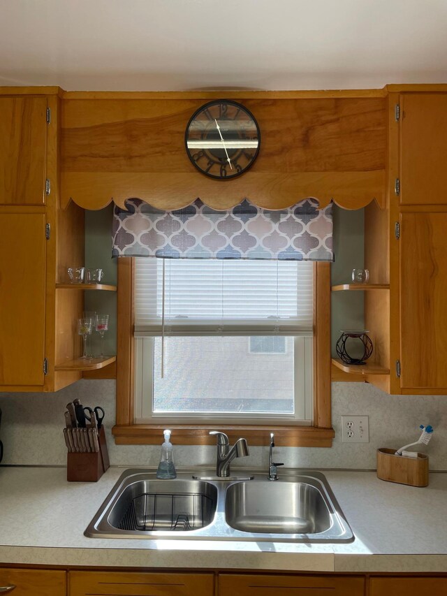 kitchen featuring tasteful backsplash and sink