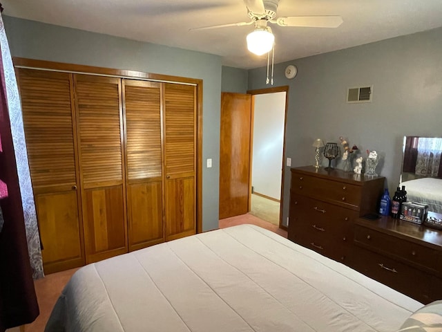 carpeted bedroom with a closet and ceiling fan