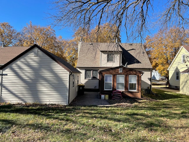 rear view of property with a yard and a patio