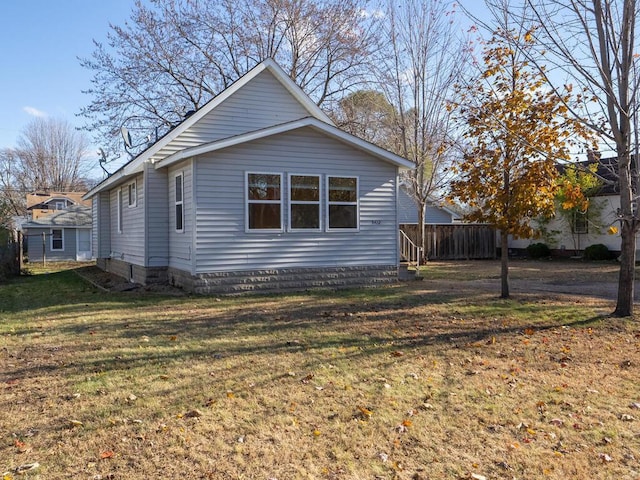 view of side of property with a yard