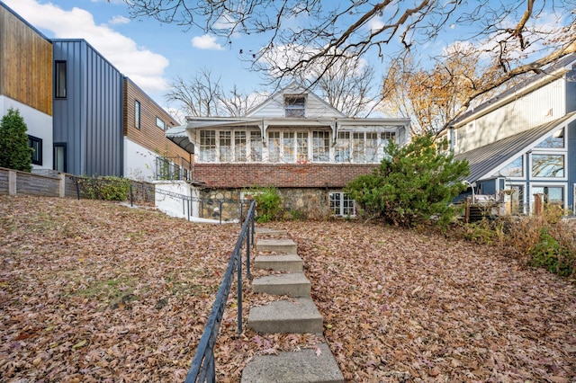 view of front of house with a sunroom