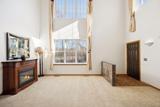 interior space with a towering ceiling and carpet floors