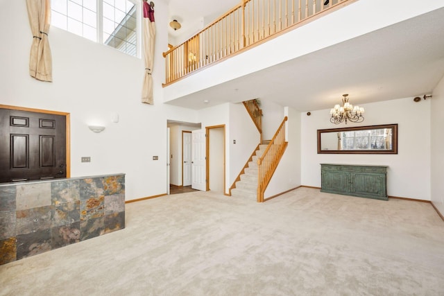 living room featuring a notable chandelier, carpet floors, and a high ceiling