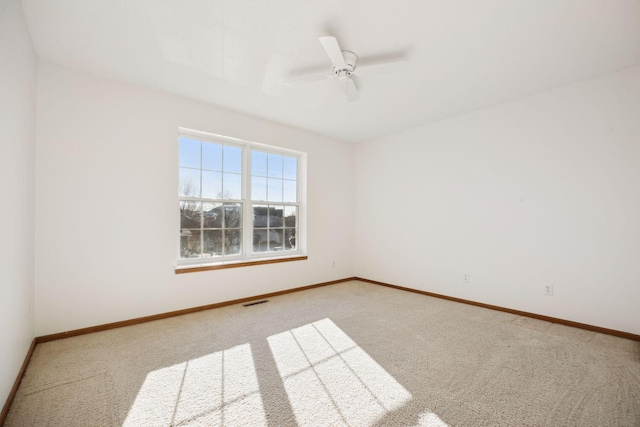 empty room with ceiling fan and carpet