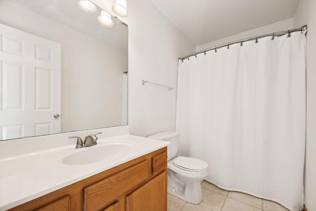 bathroom with tile patterned flooring, vanity, and toilet