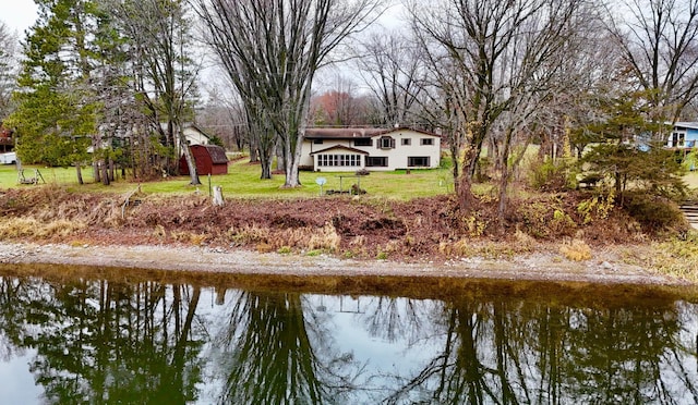 dock area with a water view and a lawn