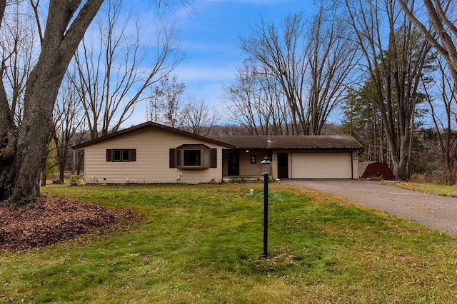 ranch-style house with a garage and a front lawn